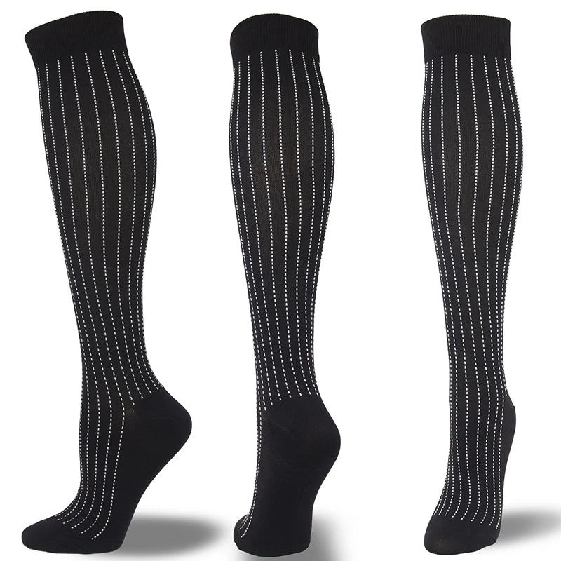 A set of black compression socks with white dotted lines shown vertically.