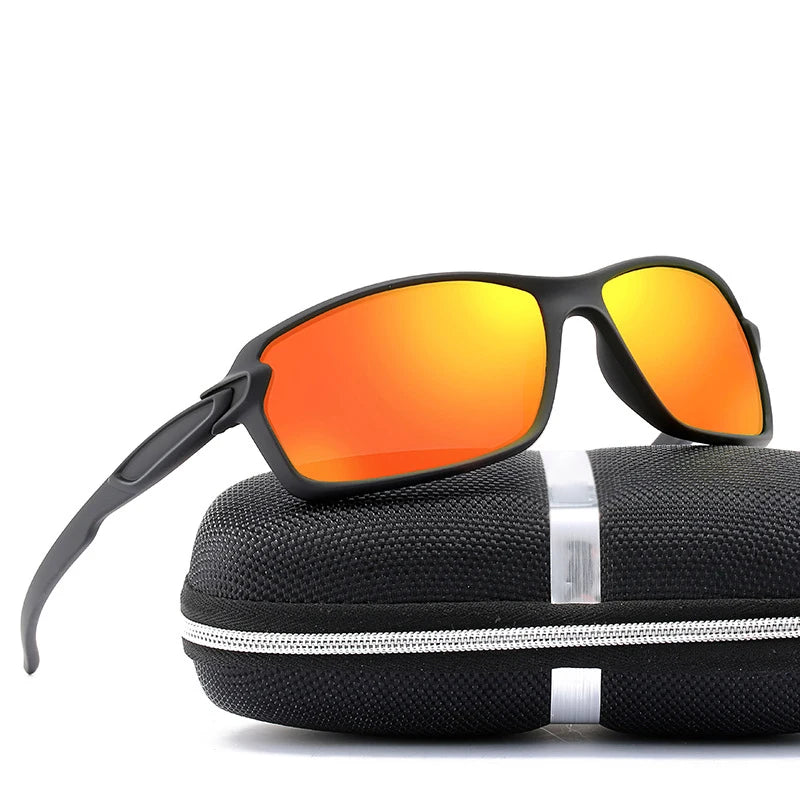 Black sports sunglasses with orange lenses resting on a black padded case.