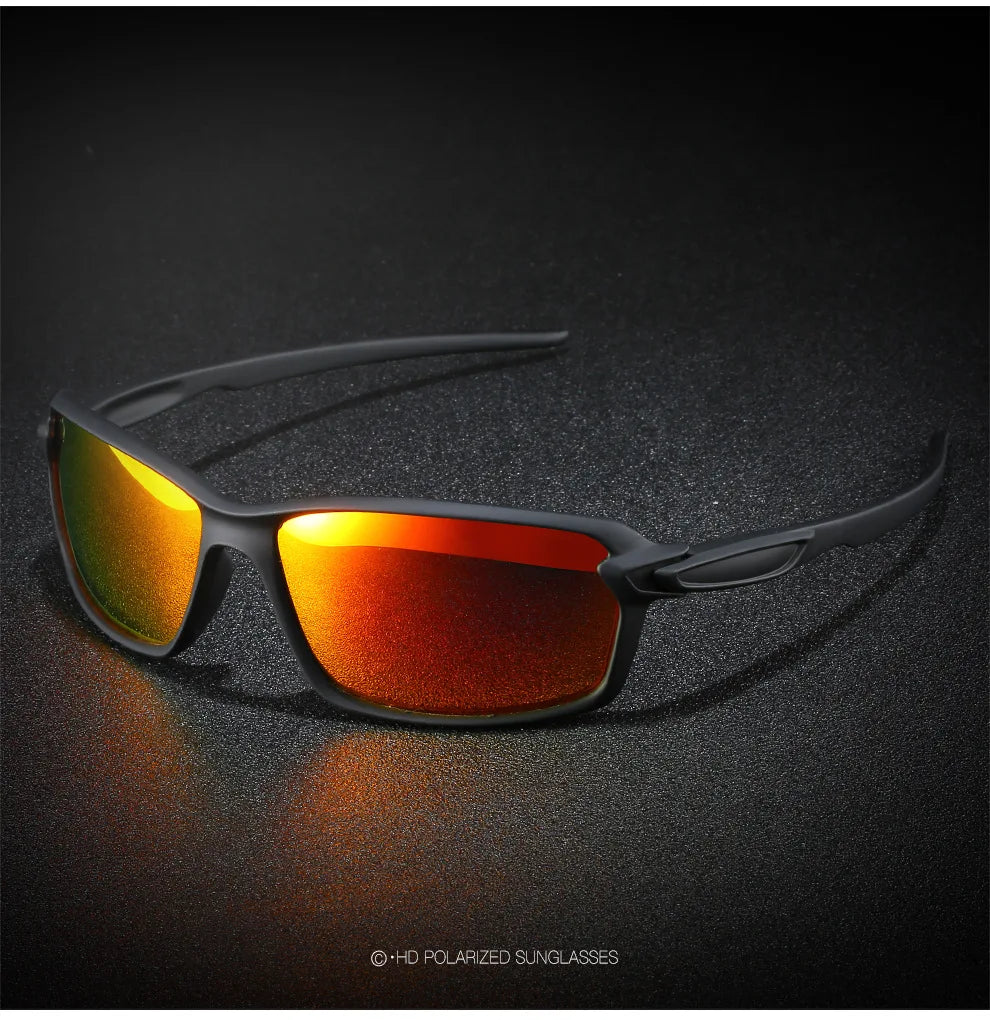 A pair of orange-tinted polarized sunglasses resting on a dark, textured surface.