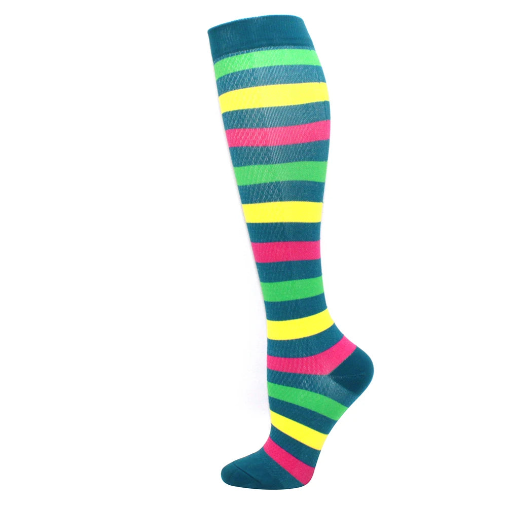 A pair of medical grade compression socks featuring horizontal stripes in green, yellow, pink, and blue.