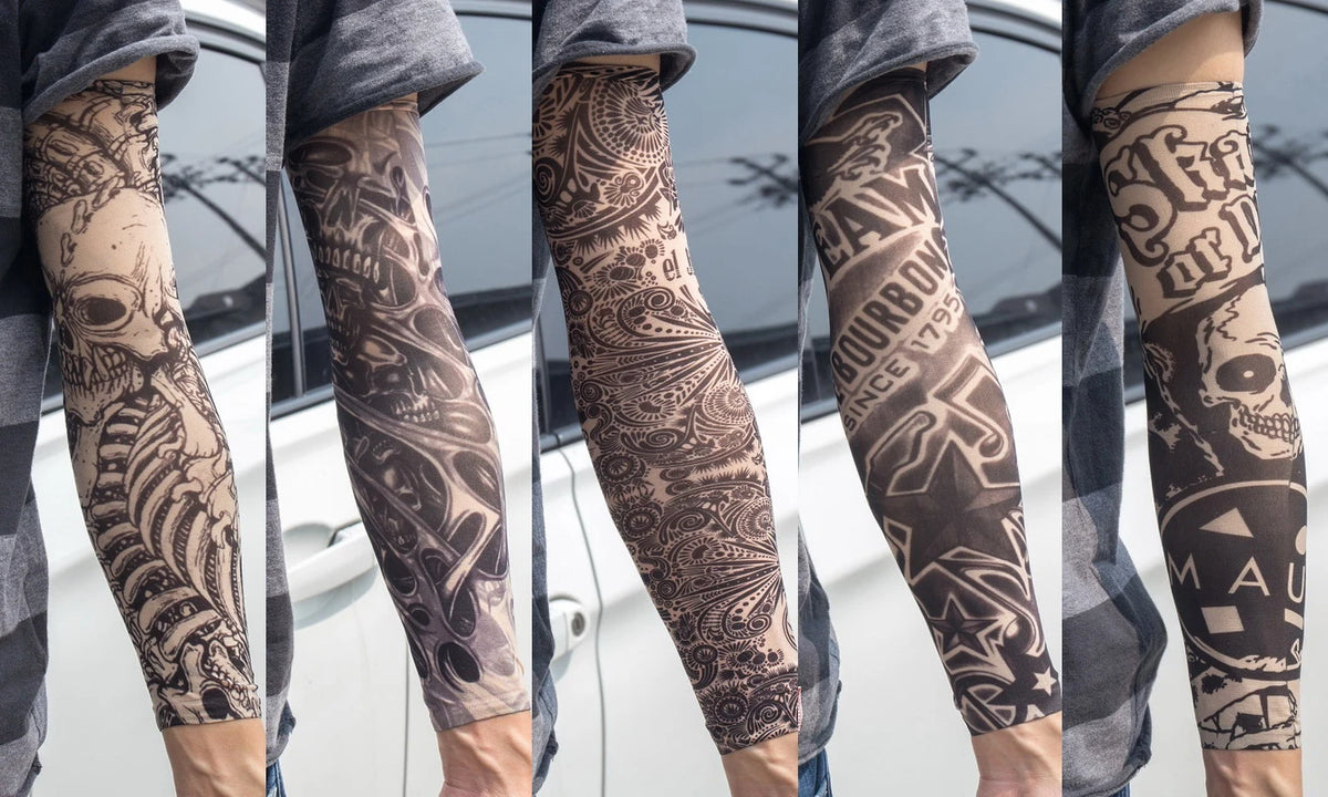 Close-up of a person wearing dark patterned tattoo arm sleeves on their forearm.