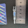 A clear lighted arrow nock is shown next to a ruler for scale.