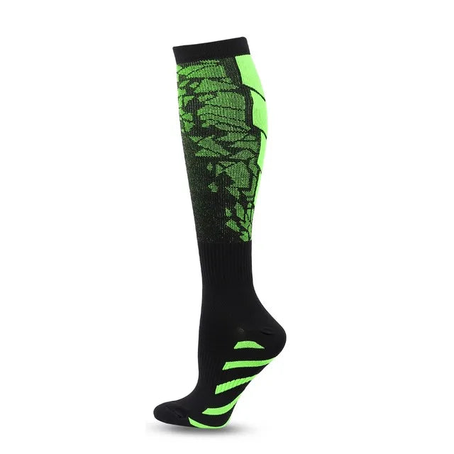 A pair of black graduated compression socks with neon green accents.