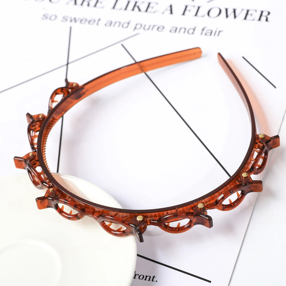 A close-up of a double layer headband made of amber-colored material adorned with small gold-colored rhinestones.