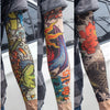 A close-up of a person wearing colorful, patterned reusable UV protection tattoo arm sleeves.