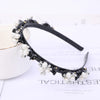 Black headband decorated with white pearls and rhinestones
