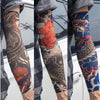 A person wearing reusable UV protection tattoo arm sleeves featuring colorful and detailed designs on their forearm.