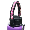 A purple water bottle with a black strap made of pink and black paracord coiled around the neck.