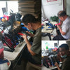 A close-up of a person assembling or inspecting lighted arrow nocks for archery equipment.