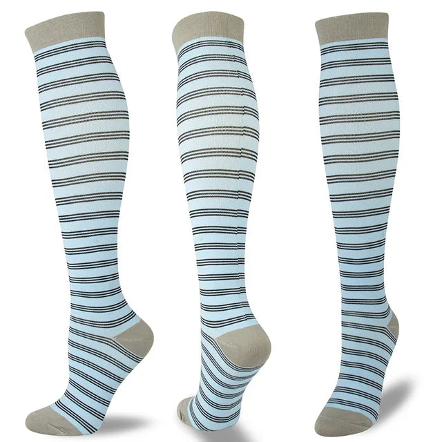 A set of multi-color striped compression socks in light blue and gray.