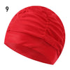 A red elastic nylon turban swimming cap shown from above.