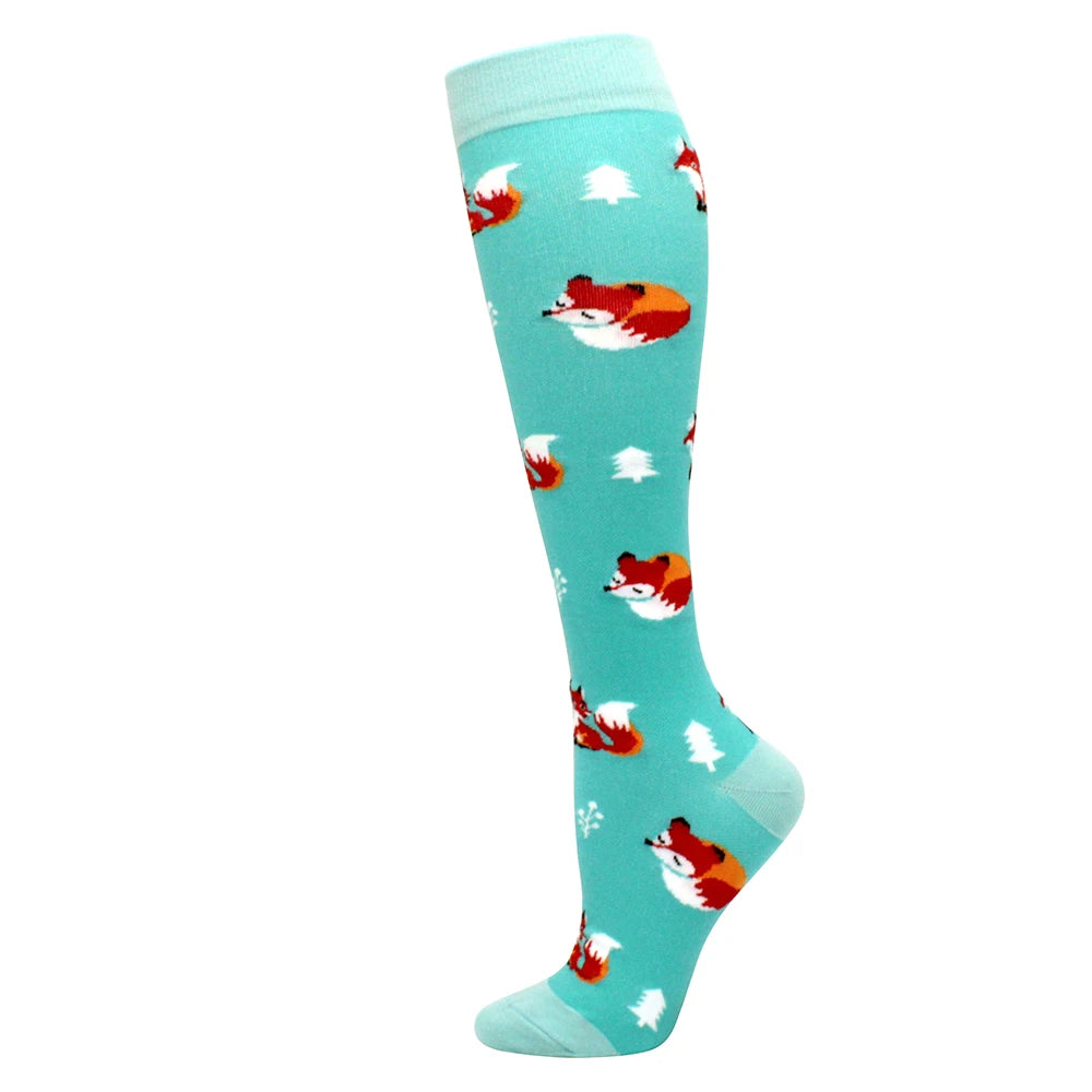 A pair of light blue compression socks featuring a repeating pattern of red and white fox silhouettes.