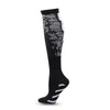 Black graduated compression socks with white stripes on the foot