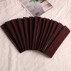 A fan of dark brown elastic headbands for sports and hair displayed on a white surface.