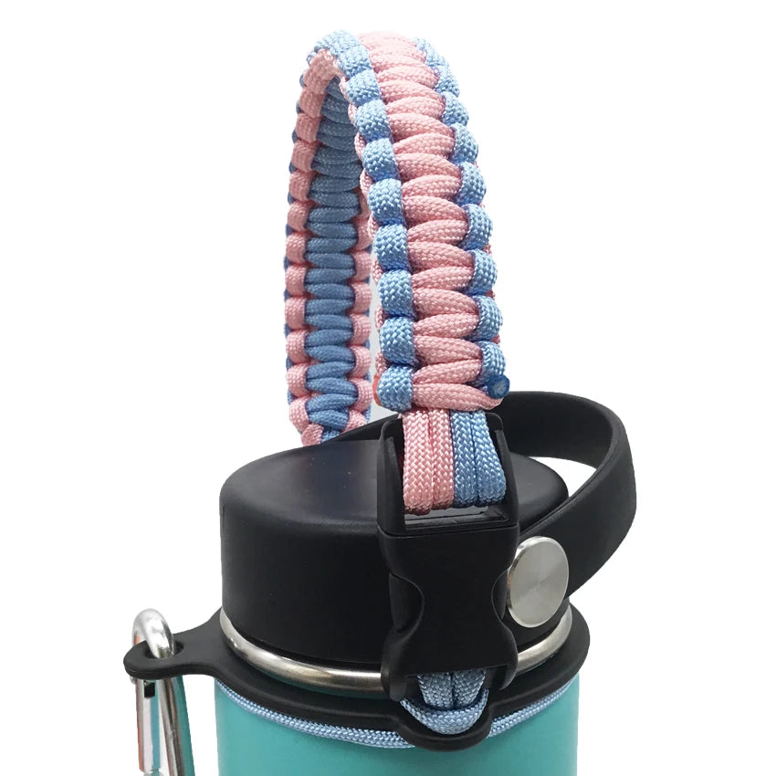A close-up of a paracord strap in pink and blue colors attached to a black water bottle.