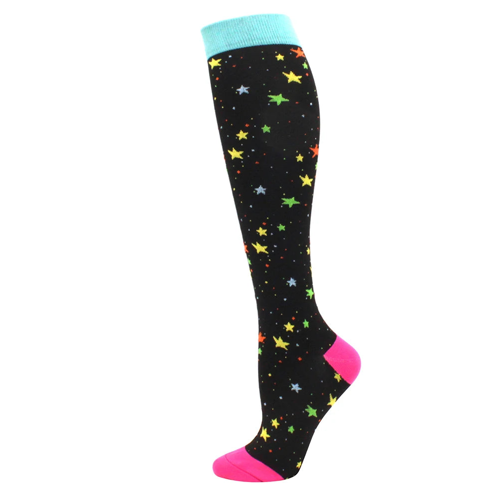 Black compression socks with a light blue cuff and yellow and green stars on the foot.
