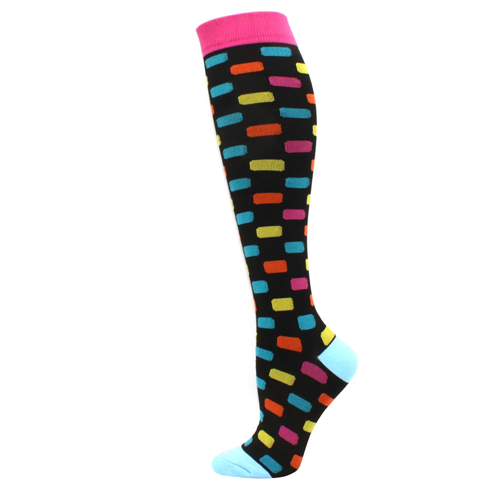 A pair of black compression socks with multi-colored stripes and a pink cuff.