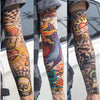 Close-up of a person wearing colorful, intricate tattoo arm sleeves for UV protection.