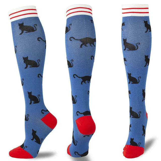 A set of multi-color compression socks featuring black cats on a blue background with red accents.