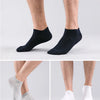 A set of women's thin cotton no-show socks in black, gray, and white shown on legs.