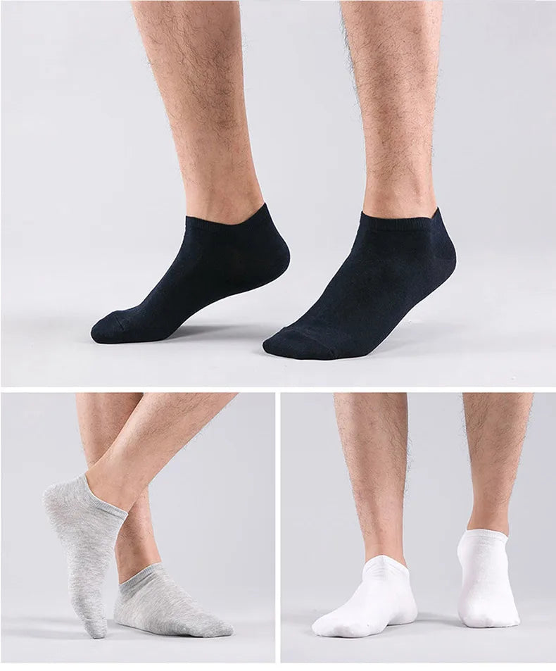 A set of women's thin cotton no-show socks in black, gray, and white shown on legs.