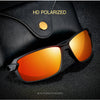 A pair of orange-tinted polarized sunglasses resting on a dark surface.