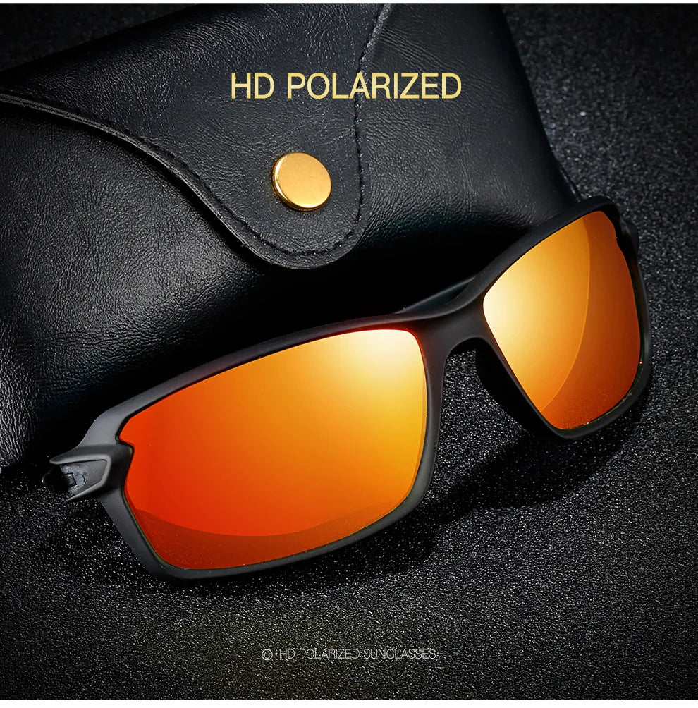 A pair of orange-tinted polarized sunglasses resting on a dark surface.