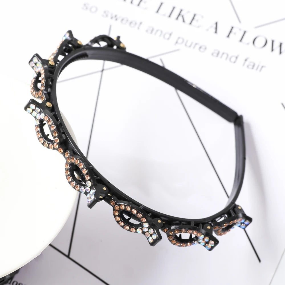 A black headband decorated with gold-toned metalwork and sparkling pearl and rhinestone accents.