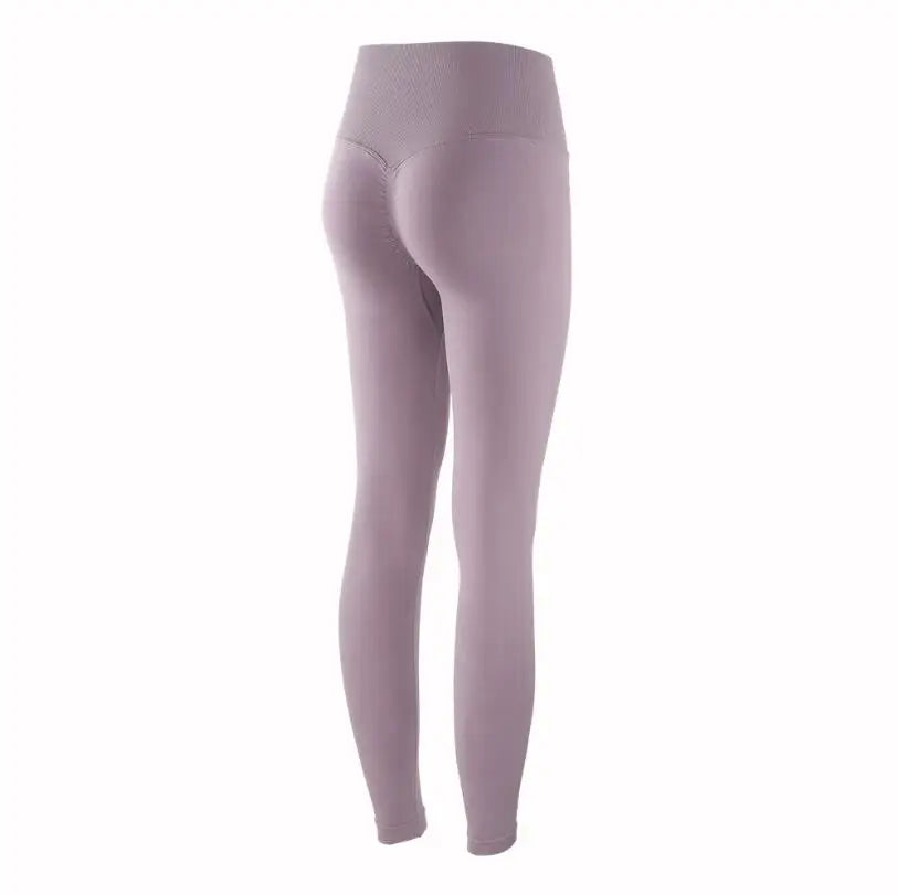 A close-up view of a mauve high-waist seamless yoga legging worn by a model.