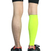 Person in bright neon yellow compression leg warmers for sports.