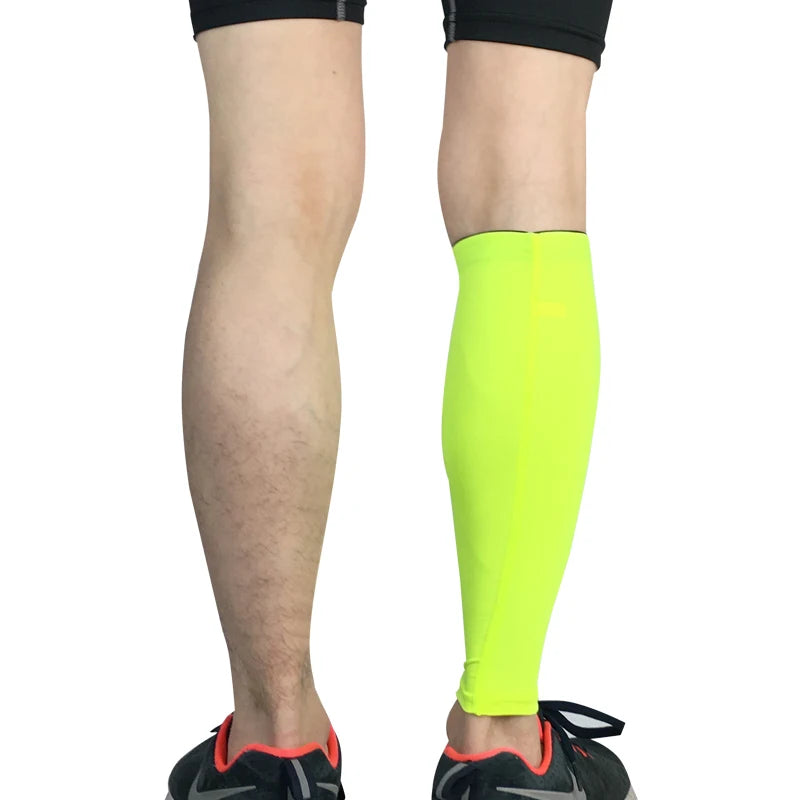 Person in bright neon yellow compression leg warmers for sports.