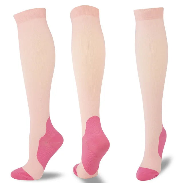 Three pairs of light pink compression socks with pink accents shown standing vertically.