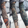 Close-up of a person wearing dark patterned tattoo arm sleeves for UV protection.
