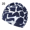 Navy and white patterned elastic nylon turban swimming cap shown from above.