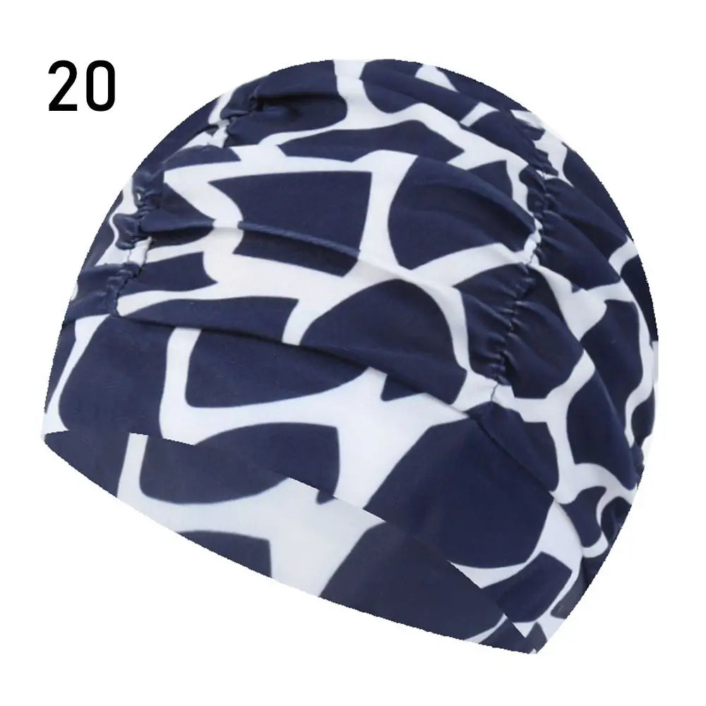 Navy and white patterned elastic nylon turban swimming cap shown from above.