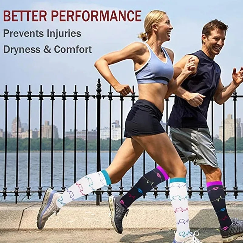 A woman and a man running outdoors wearing multi-color compression socks for support.