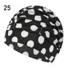 Black and white polka dot elastic nylon turban swimming cap shown from the side.