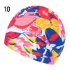 A vibrant, multi-colored elastic nylon turban swimming cap featuring a floral pattern.