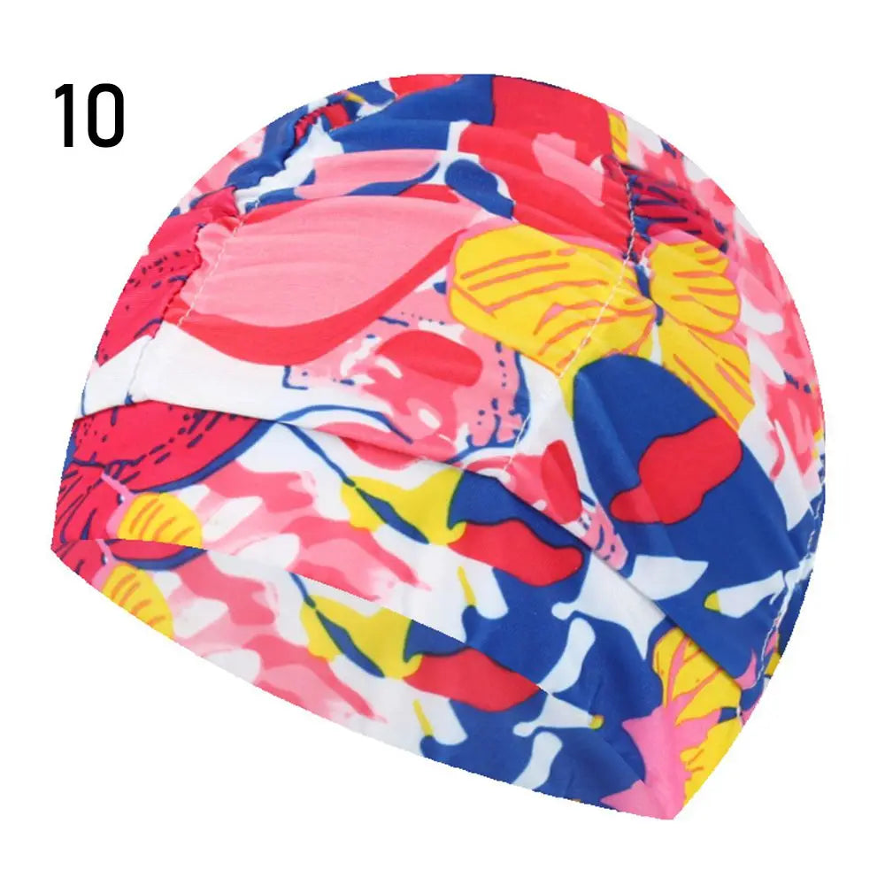 A vibrant, multi-colored elastic nylon turban swimming cap featuring a floral pattern.