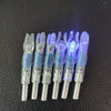 A row of lighted arrow nocks for archery, showing various plastic and metal components.