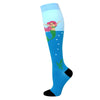 A pair of light blue compression socks featuring a pink mermaid design.