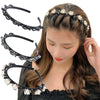 A woman models a black headband decorated with pearls and rhinestones, styled in an updo.