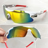 A pair of yellow-tinted sport sunglasses with white frames and red accents are shown in a close-up view.