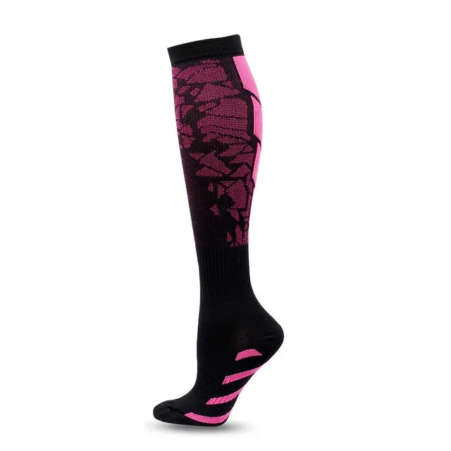 A pair of black graduated compression socks with pink accents and a patterned design.