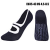 A pair of navy blue women's pilates and yoga socks, one shown flat and the other standing upright.