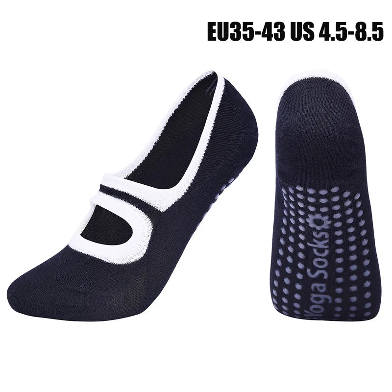 A pair of navy blue women's pilates and yoga socks, one shown flat and the other standing upright.