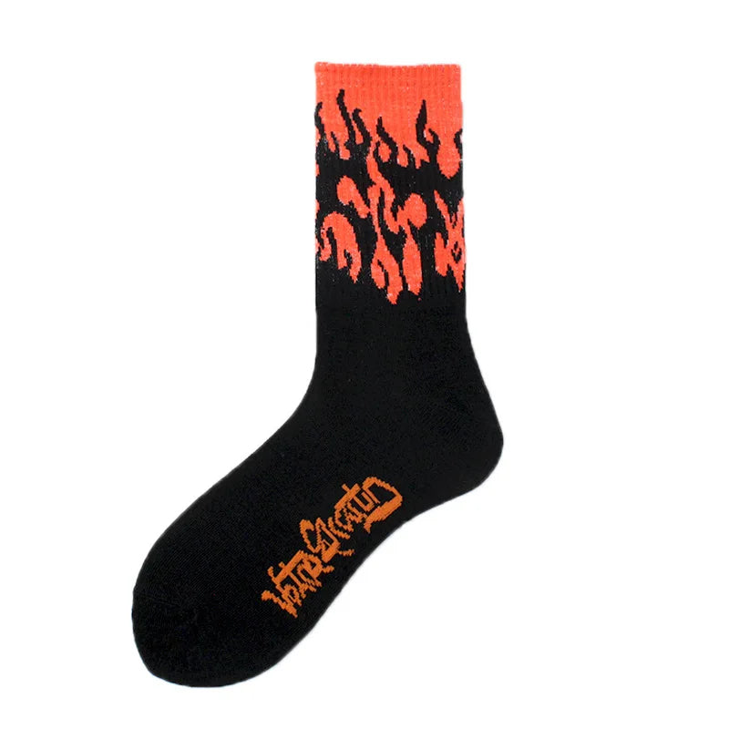 A pair of black crew socks with an orange flame pattern on the top cuff.