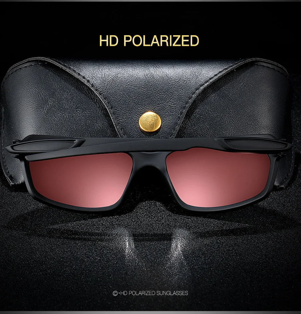 A pair of black polarized sunglasses with gold accents resting on a dark surface.