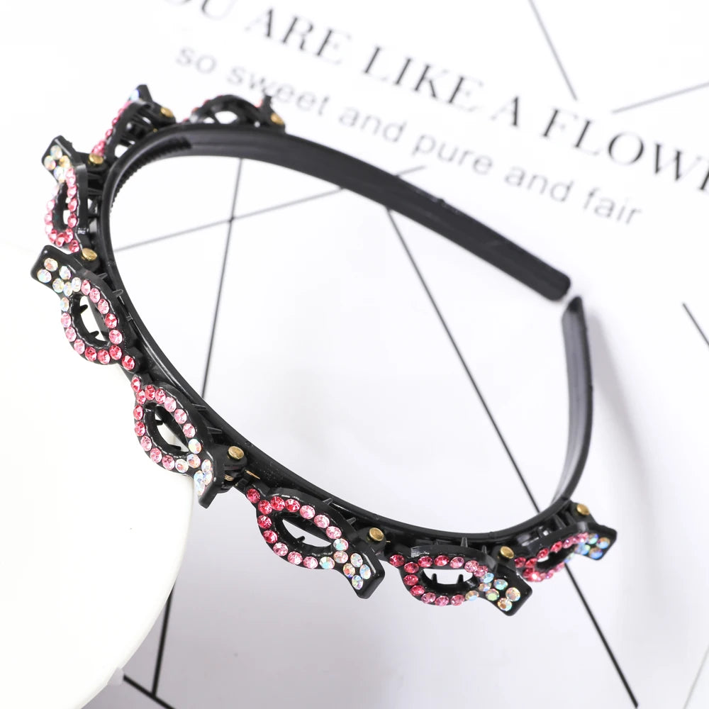 A black headband decorated with pink and clear rhinestones and pearls.
