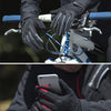 Close-up of hands wearing black cycling gloves gripping a bicycle handlebar and displaying a smartphone.